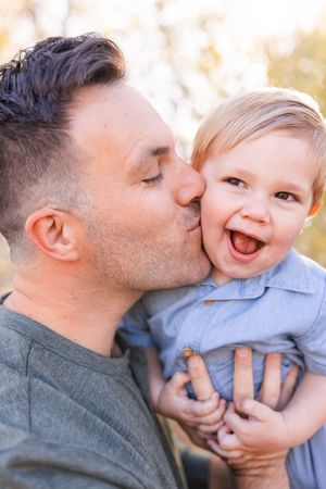 salt lake city utah family photographer, candid photo of a dad kissing toddler