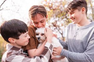 salt lake city utah family photographer, candid photo of a teenage boy siblings snuggling dog