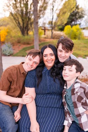 salt lake city utah family photographer, candid photo of a teenage boy siblings snuggling mom