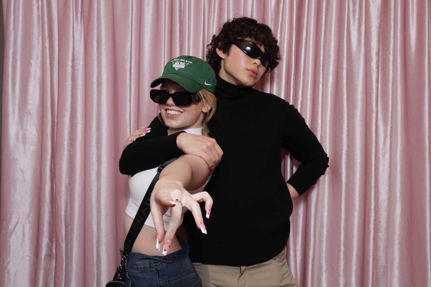 a woman and man posing in a photobooht