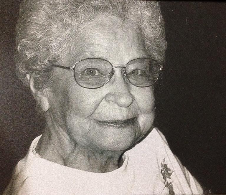End-of-life photograph of an elderly woman smiling at the camera. Blue Onion Photography.