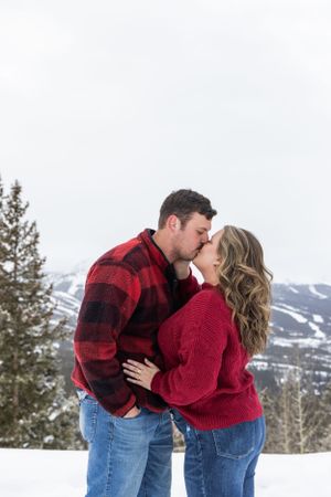 couple kissing during beautiful winter afternoon
