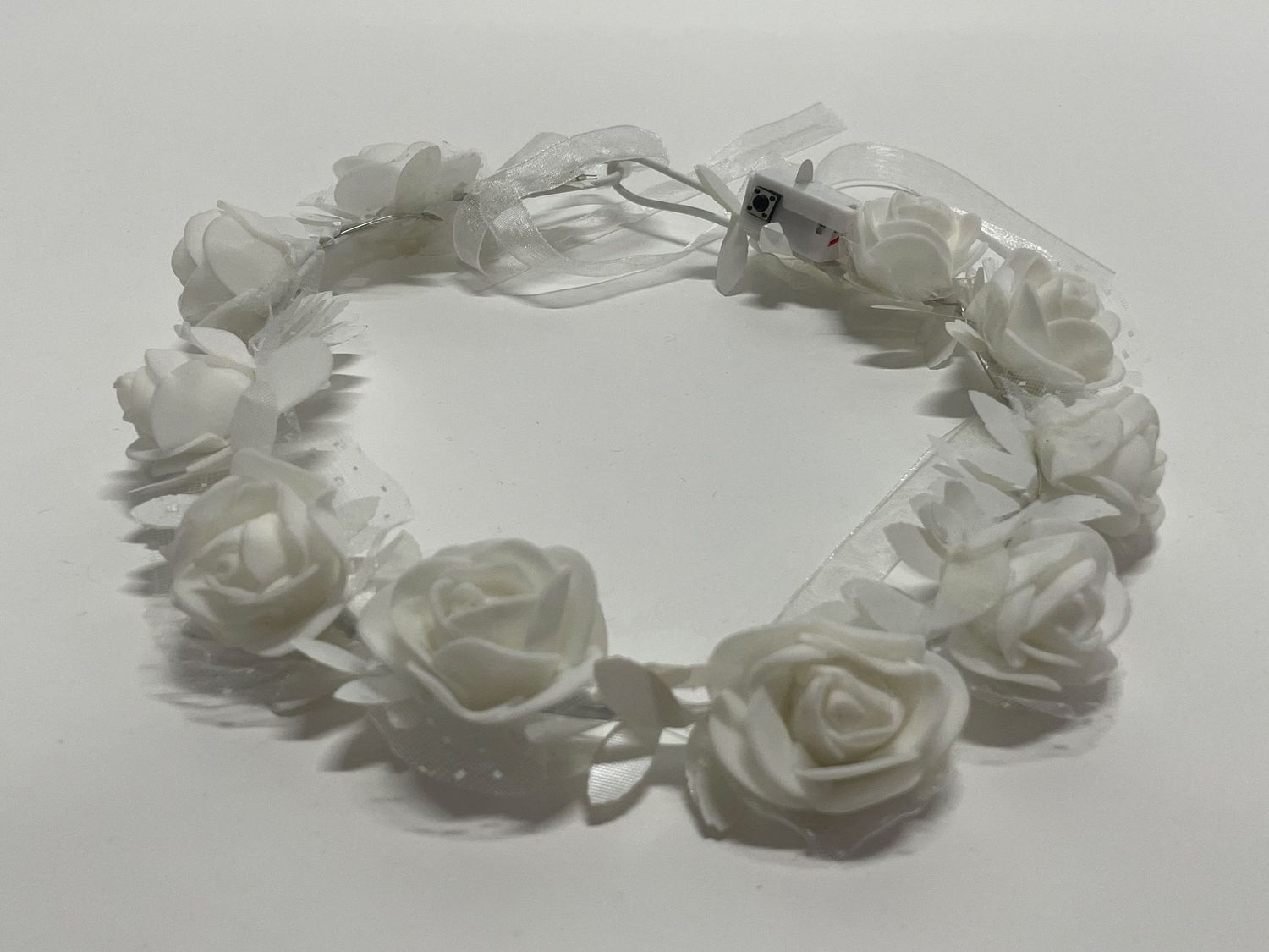 White rose flower crown with satin ribbon details.