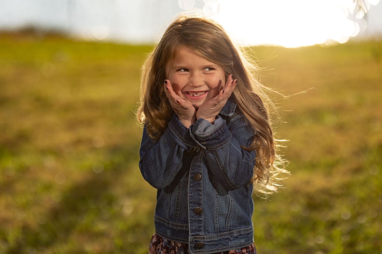 Cute little girl makes faces in the fading evening light.