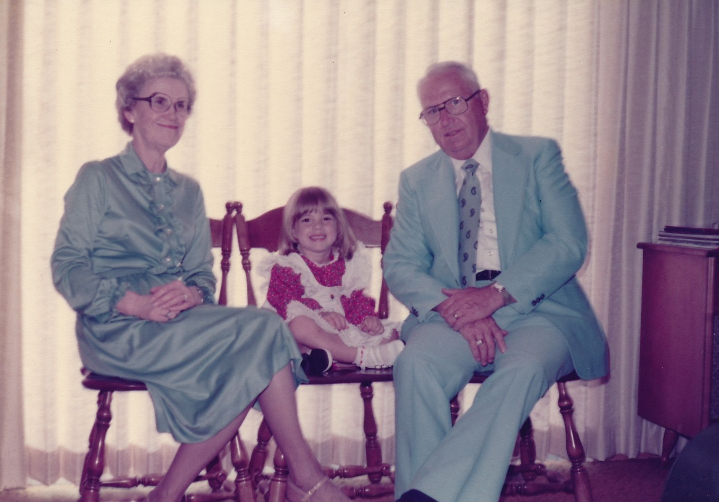 Granny Maxine and Grandpa Wasson Kent in matching baby blue dress clothes pose with granddaughter Courtney Kent. 1970s
