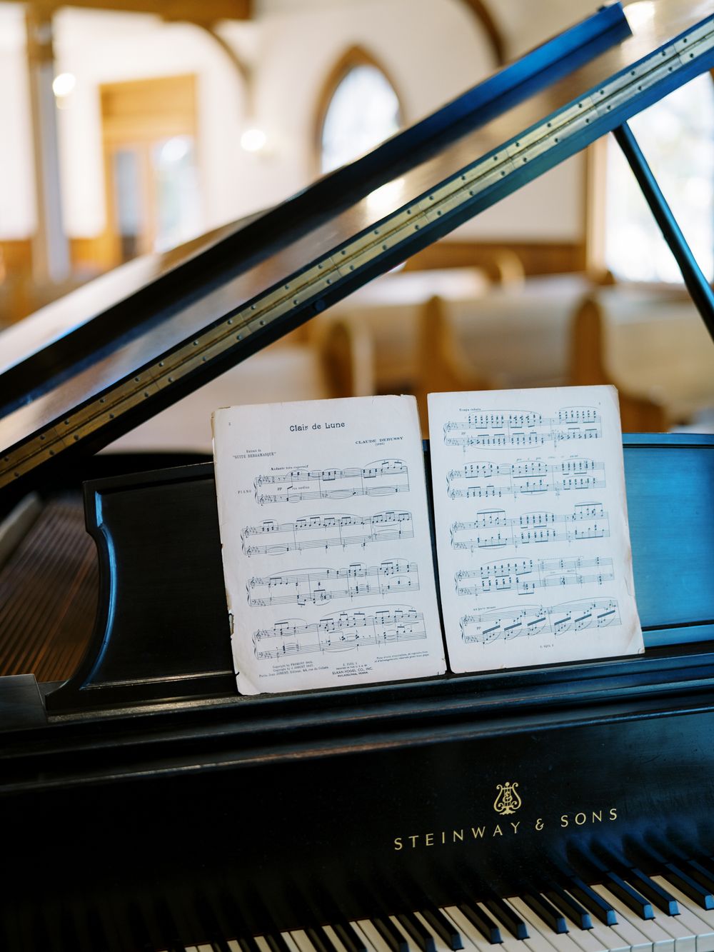 Sheet music displayed on a Steinway & Sons grand piano.