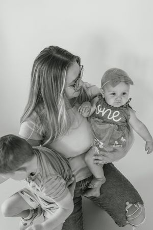 Black and white sequence showing tender moments between parent and child in playful poses.