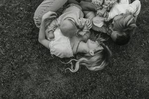 Black and white photographs showing multiple children tumbling and rolling down a grassy slope.