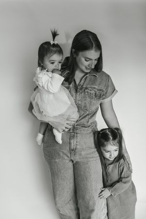 A sequence of black and white photographs showing tender moments between a parent and child in denim overalls.