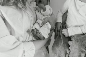 A collection of black and white photographs arranged in a horizontal strip showing intimate family moments.