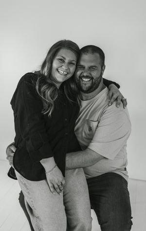 A couple embraces and laughs together in a series of black and white candid photos showing their playful connection.