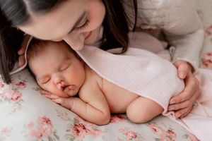 Six gentle newborn portraits in white outfits on pink background showing peaceful sleeping poses.