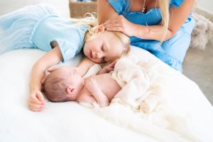 Professional lifestyle newborn photography session with soft natural lighting.