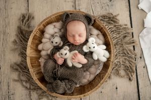 Five connected images show a peaceful sleeping figure wrapped in soft knit blankets with stuffed animals in a wooden basket.