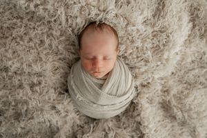 Set of newborn photography images in cream and beige tones with textured backgrounds.