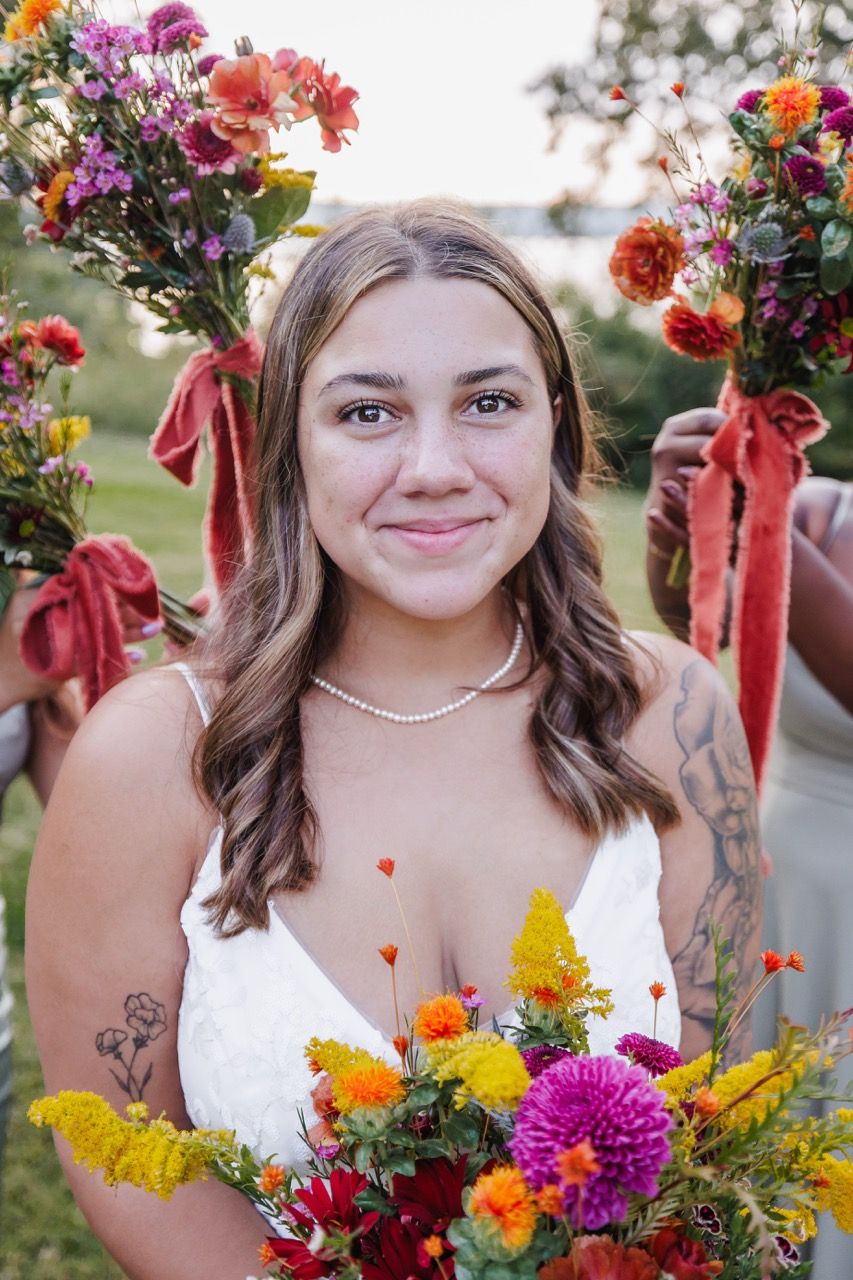 Bride holding a lush floral bouquet in a Snohomish venue. Tim Neal Photography specializes in intimate weddings.