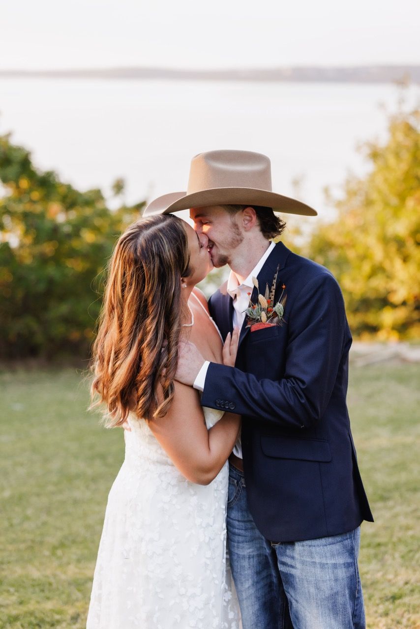 Sweet, quiet kiss between newlyweds in a sun-drenched Snohomish field. Tim Neal Photography.