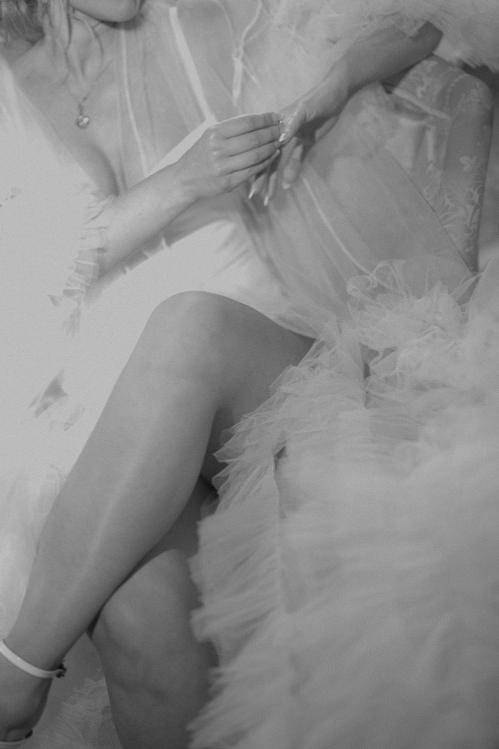 Black and white artistic photo of a dress with tulle fabric details.