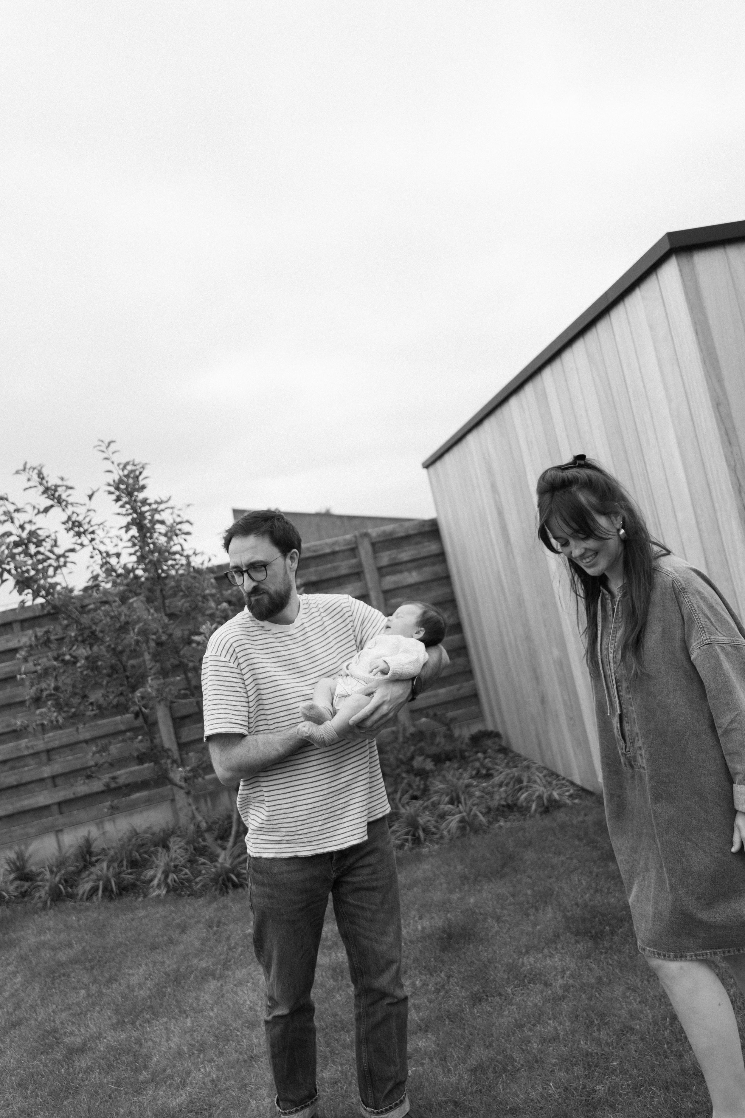 Black and white candid moments captured between people in an outdoor setting.