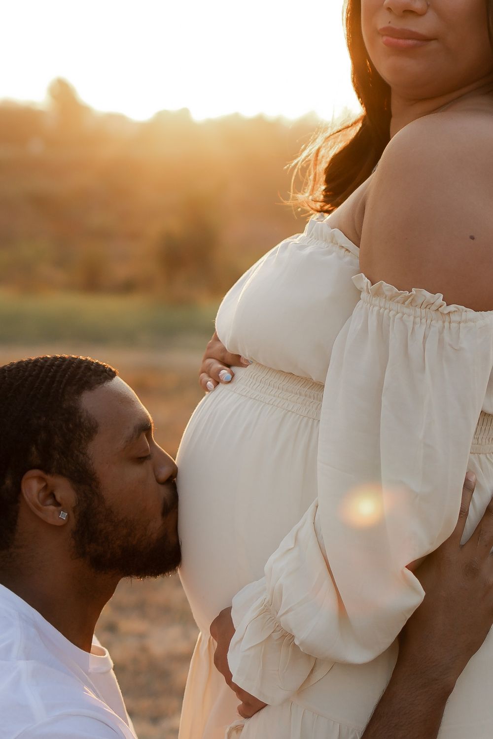 Intimate maternity photo captured during golden hour showing gentle embrace.