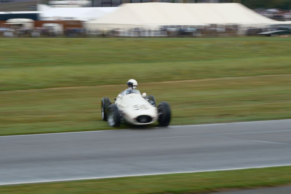 Vintage race car drifting sideways at Goodwood Revival