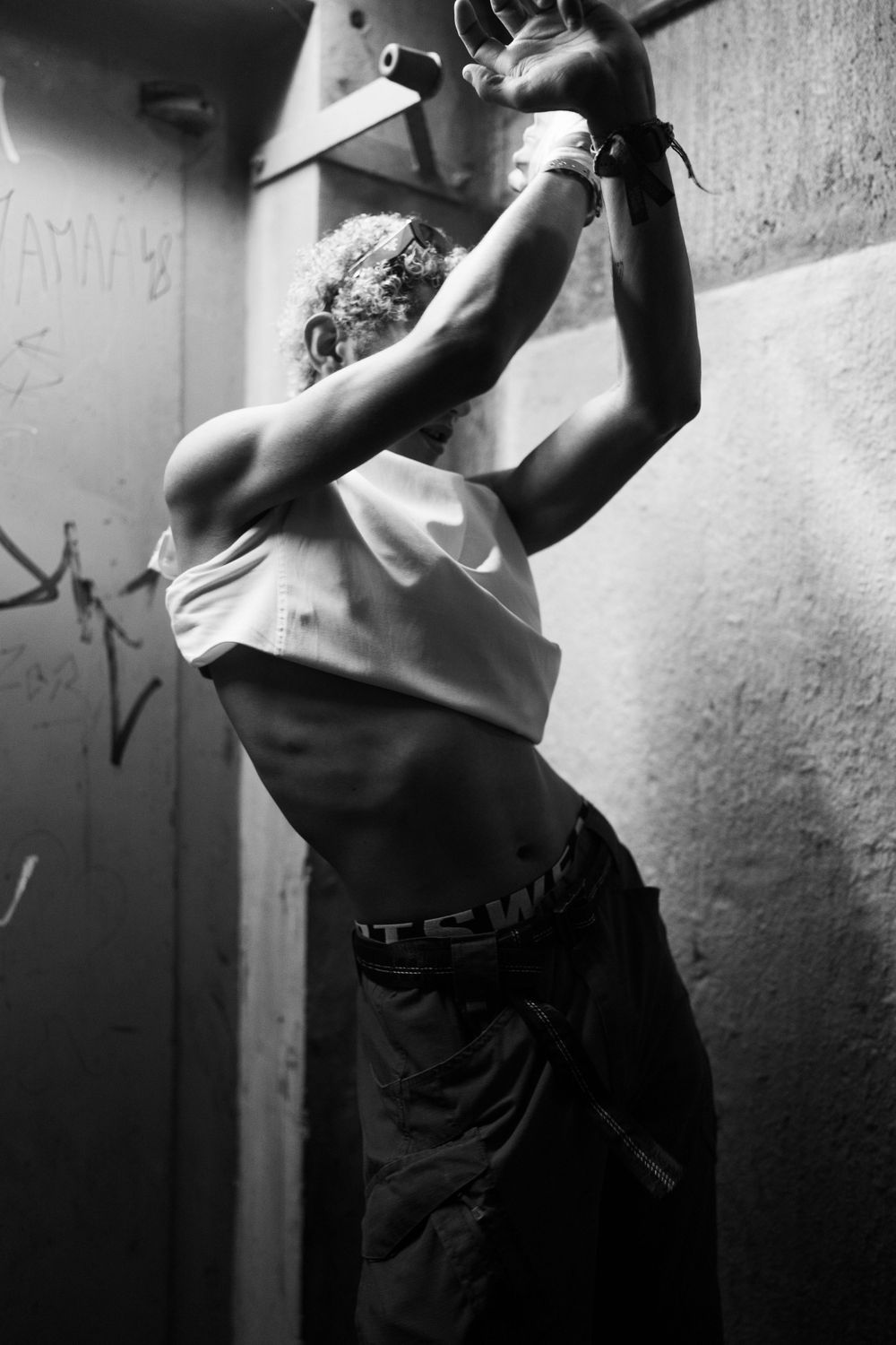 Black and white sequence showing a person in motion against a white wall.