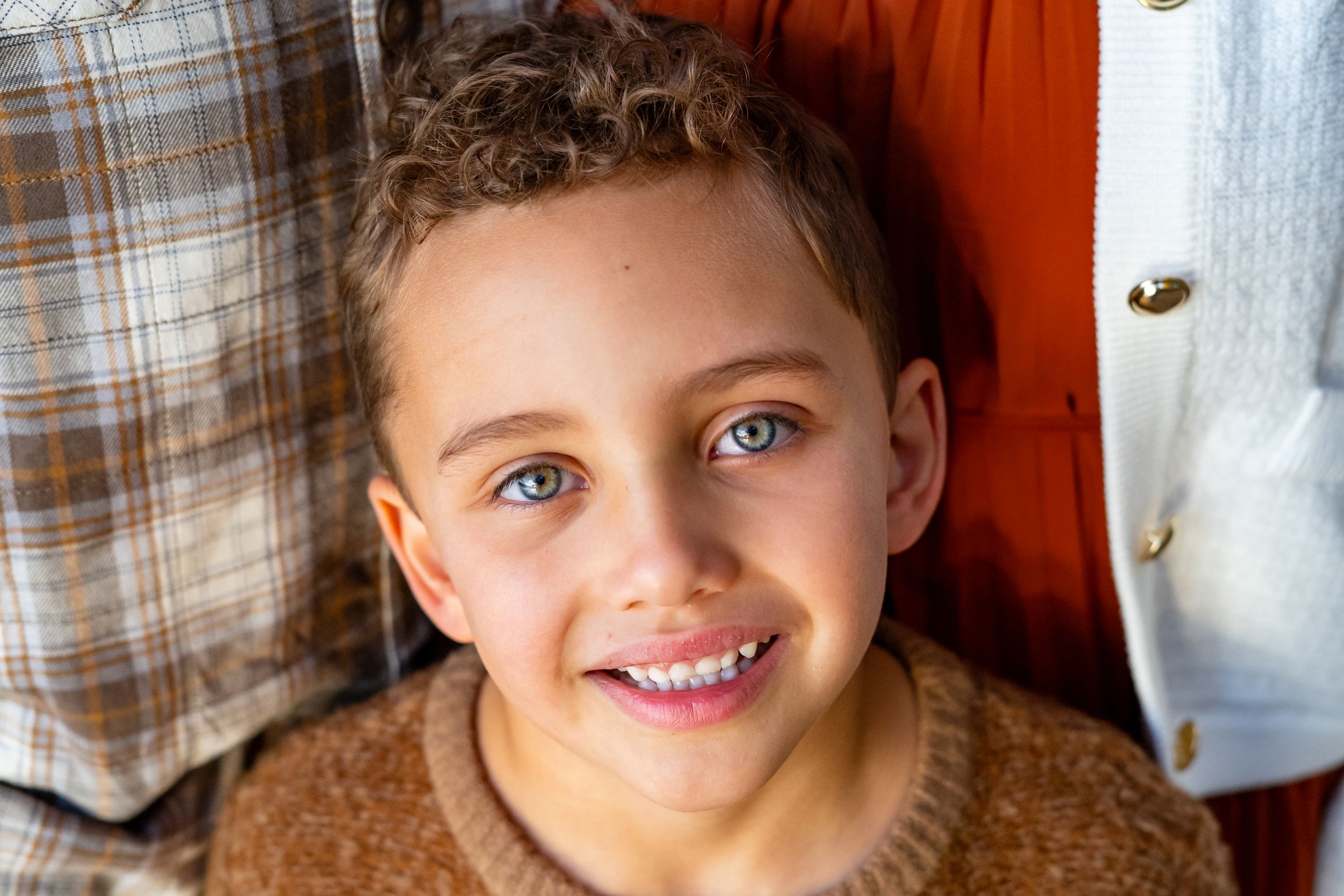 Close up portrait with bright blue eyes and warm smile.