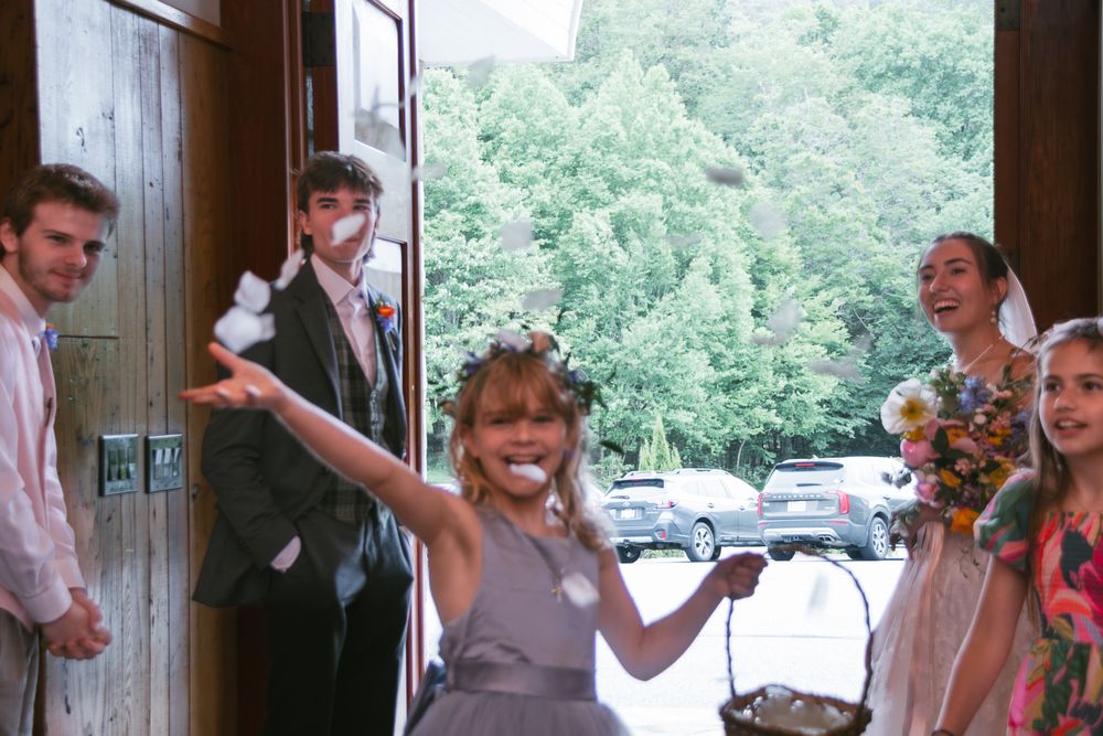 Candid reception moments with guests in rustic wood-paneled venue. Historic venue wedding photographer North Carolina