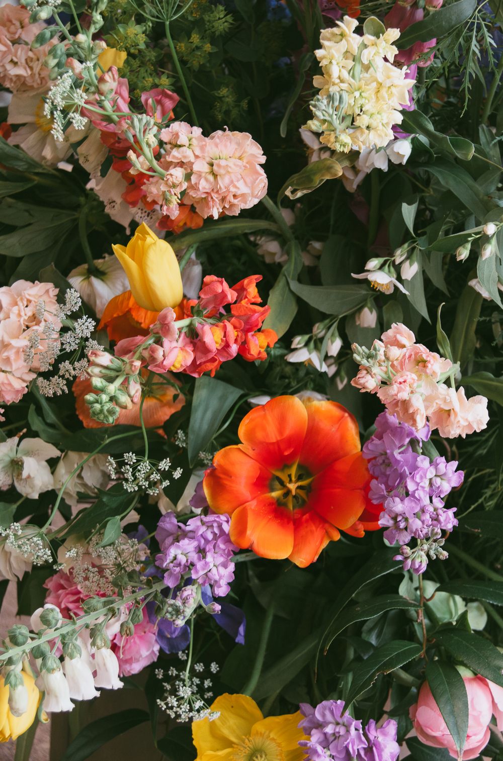 Colorful floral arrangement featuring orange tulips, purple stocks, and pink blooms. Historic venue wedding photographer North Carolina