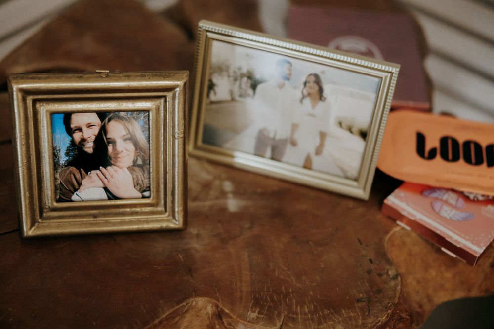 Vintage framed photographs displayed on wooden surface showing family memories.
