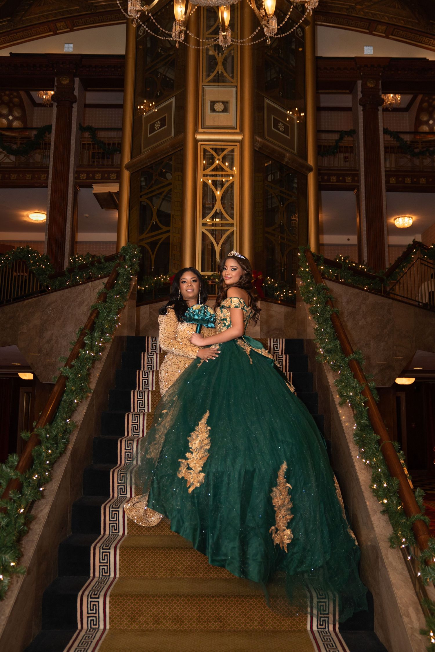 Elegant photos of someone in an emerald green ballgown on a grand staircase with holiday decorations.