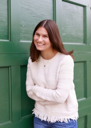 Portrait series featuring someone wearing a white sweater against a green paneled door.