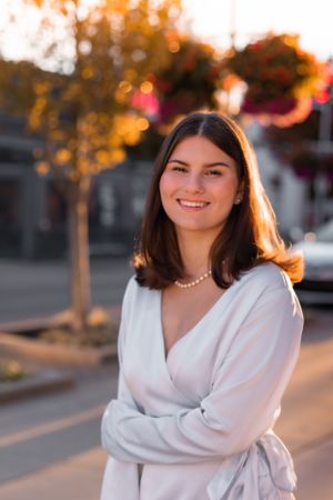 Golden hour portrait session with warm autumn lighting and urban background.