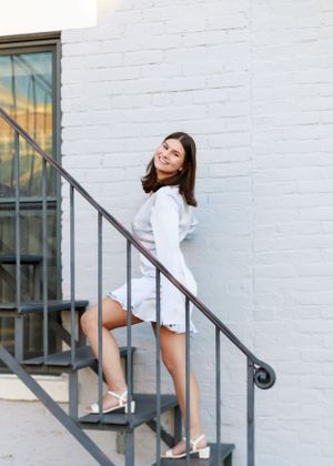 Dynamic poses on white painted stairs showcasing movement and elegance.