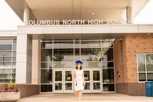Exterior view of Columbus North High School entrance with brick facade and glass doors.