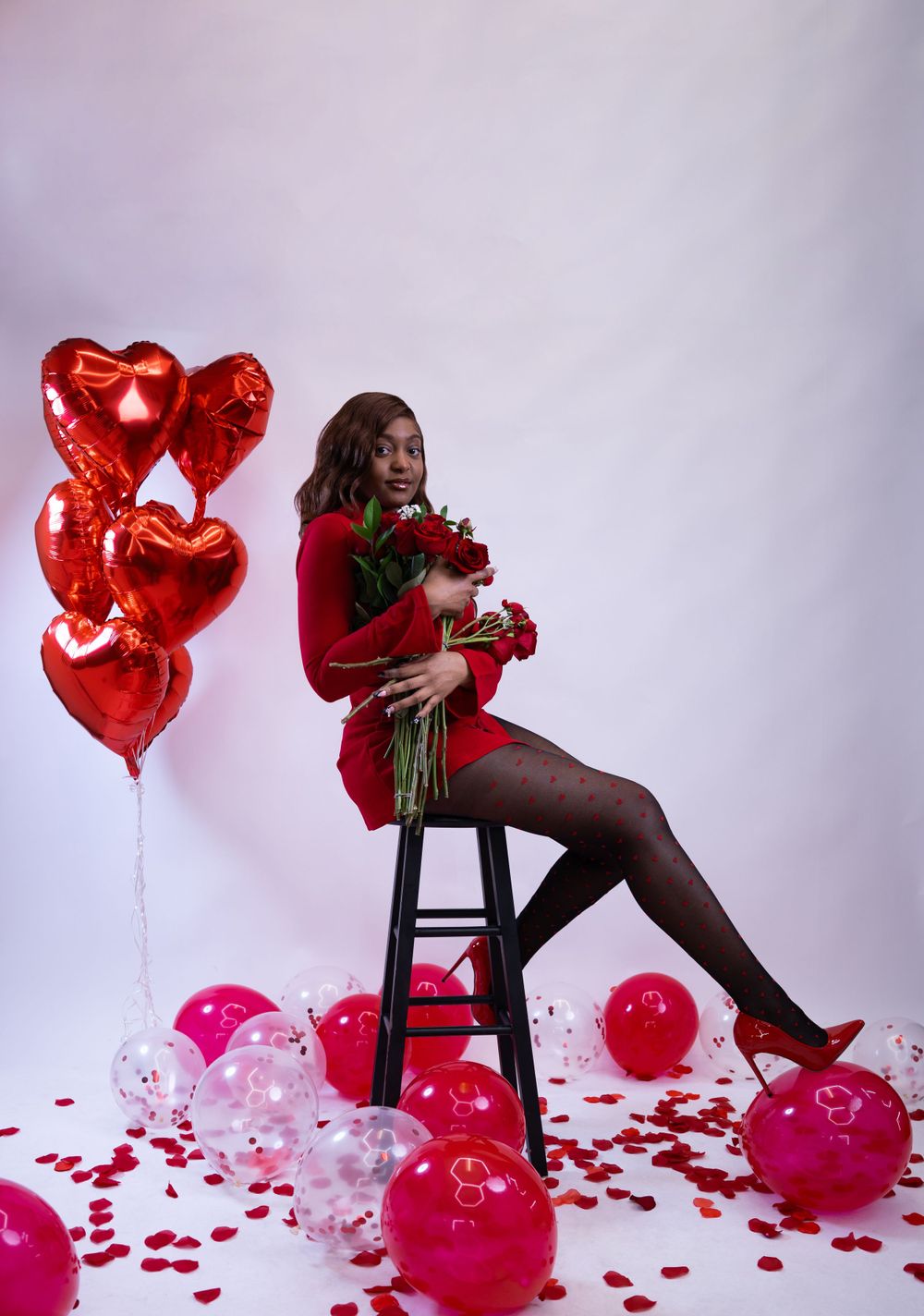 Intimate studio Valentine’s photoshoot with red and pink decorations