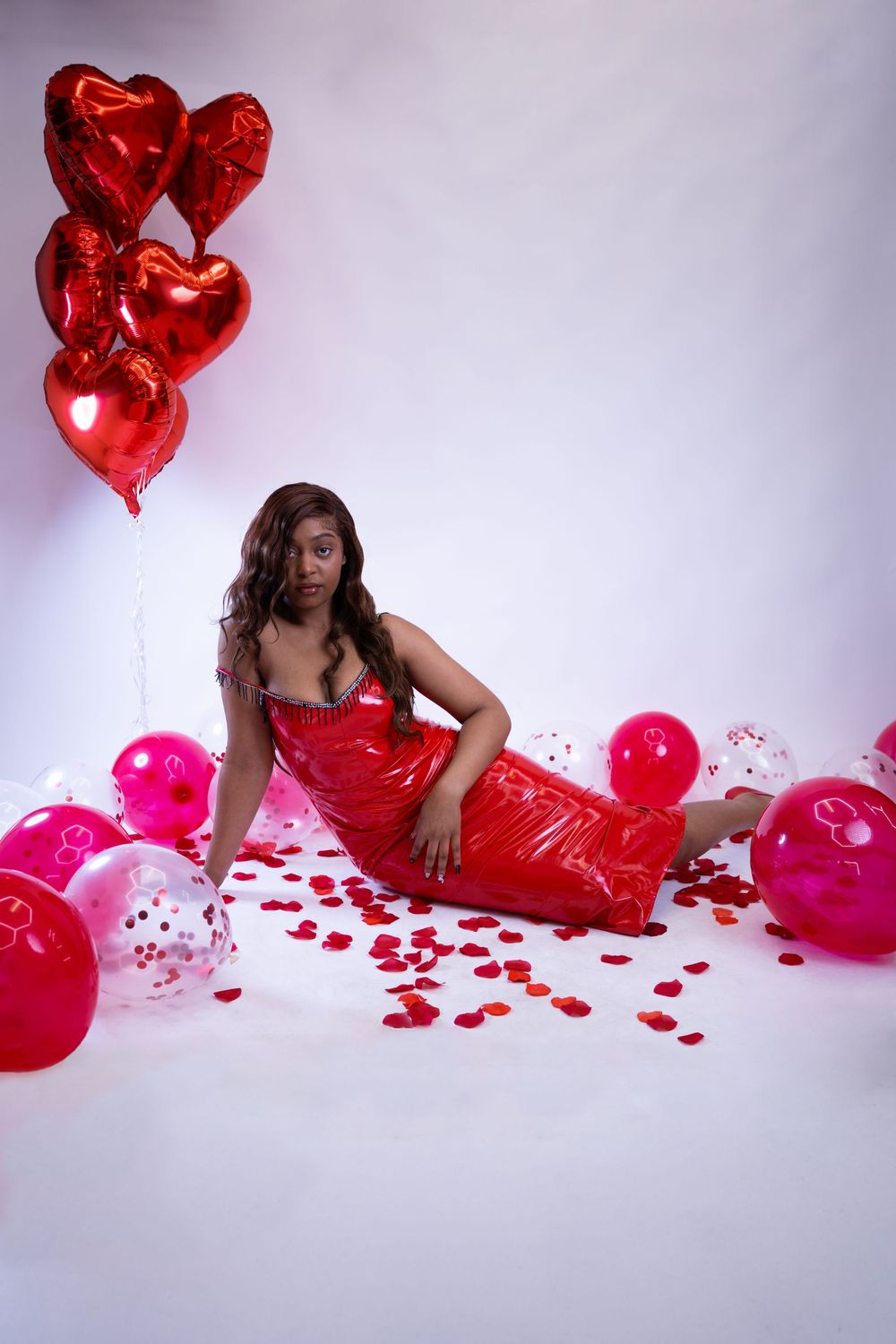 Intimate studio Valentine’s photoshoot with red and pink decorations