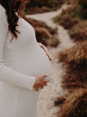 A series of intimate maternity photos showing a pregnant figure in a white dress against a natural outdoor backdrop.