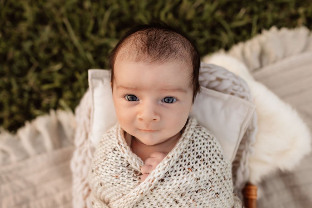 Newborn lifestyle session in Lincolnton NC with baby swaddled in neutrals