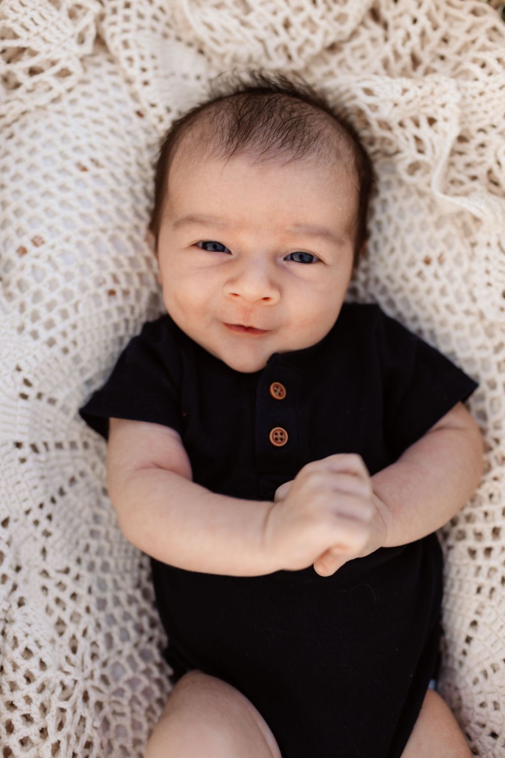 Newborn lifestyle session in Iron Station NC with baby swaddled in neutrals