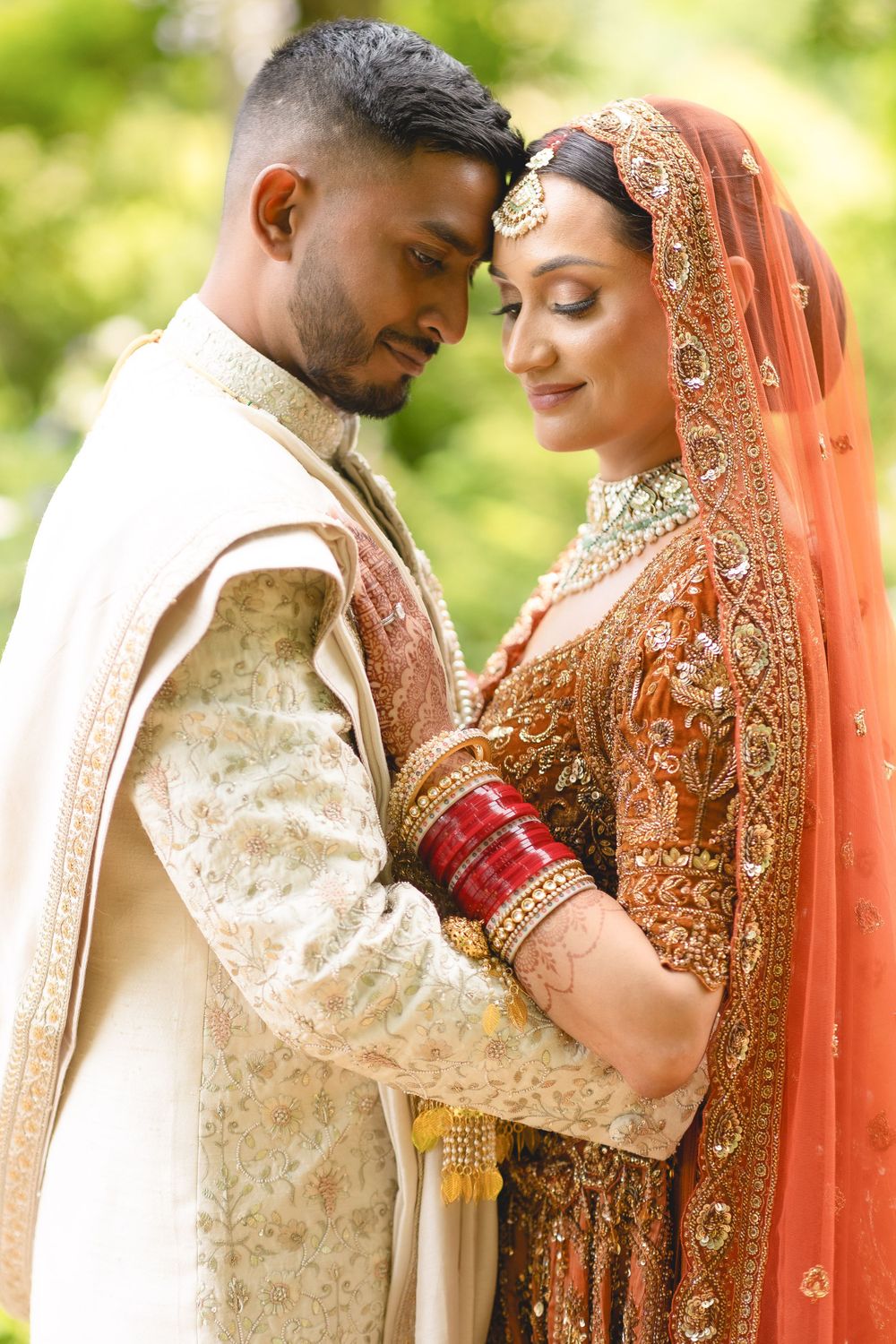 Intimate moment between newlyweds wearing traditional Indian wedding attire and jewellery. Asian Wedding Photography & Videography