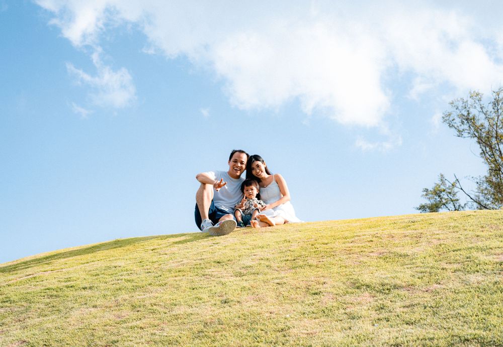 Two people relaxing together on a sunny hilltop enjoying the outdoors.
