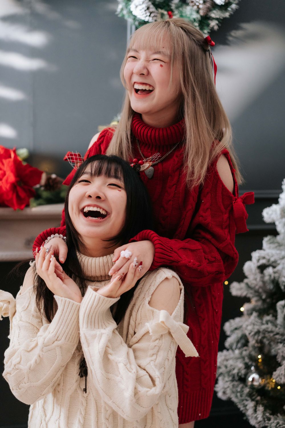 Holiday portrait session with red sweaters and festive decorations.