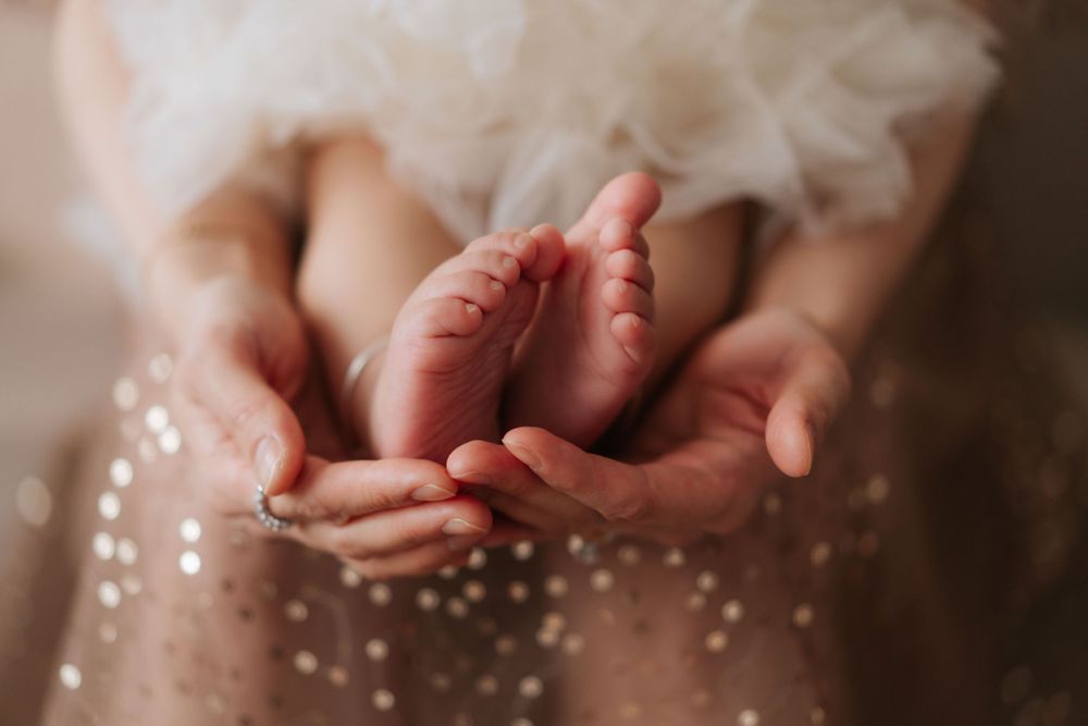 Close-up photograph showing hands with soft bokeh lighting effects.