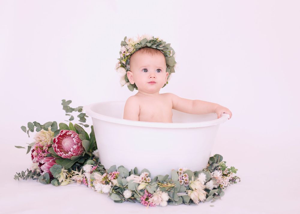 Whimsical bath photo with vintage tub surrounded by pink and green florals.