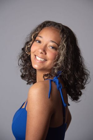 Portrait of model, smiling, with blue dress