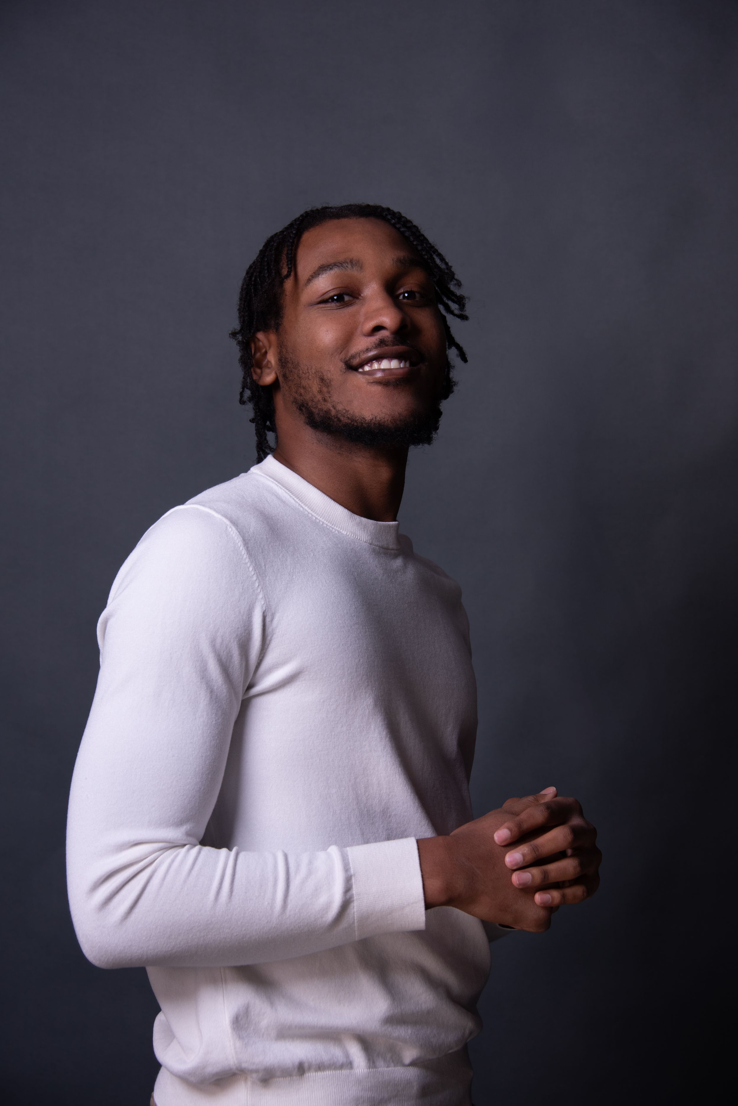 Musician and artist, posing confidently for his portrait.