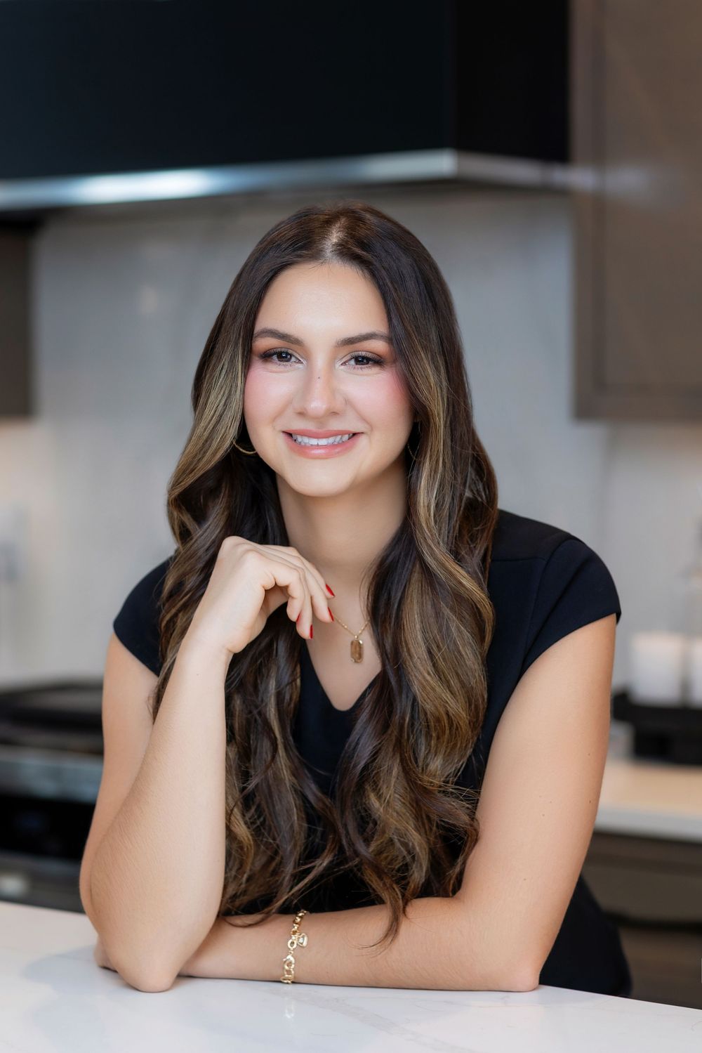 Professional headshot portraits in a modern kitchen setting with warm lighting and natural poses.
