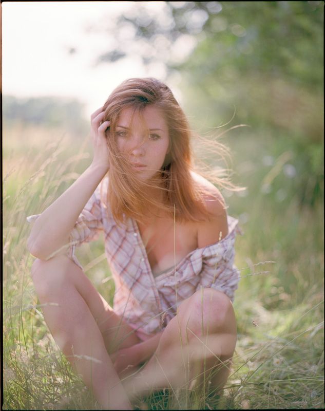 Dreamy summer portrait in tall grass during golden hour.