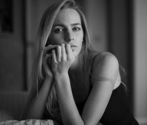 Intimate black and white portrait showing contemplative mood and soft lighting.